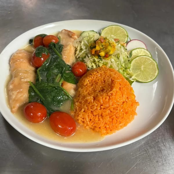 El Agave Mexican Cuisine's chicken dish with rice, spinach, tomatoes, and lime slices.
