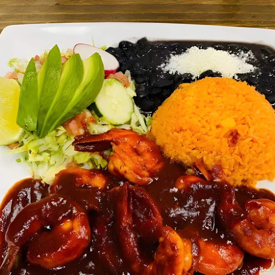 El Agave's Camarones a la Diabla with rice, black beans, and a fresh salad.